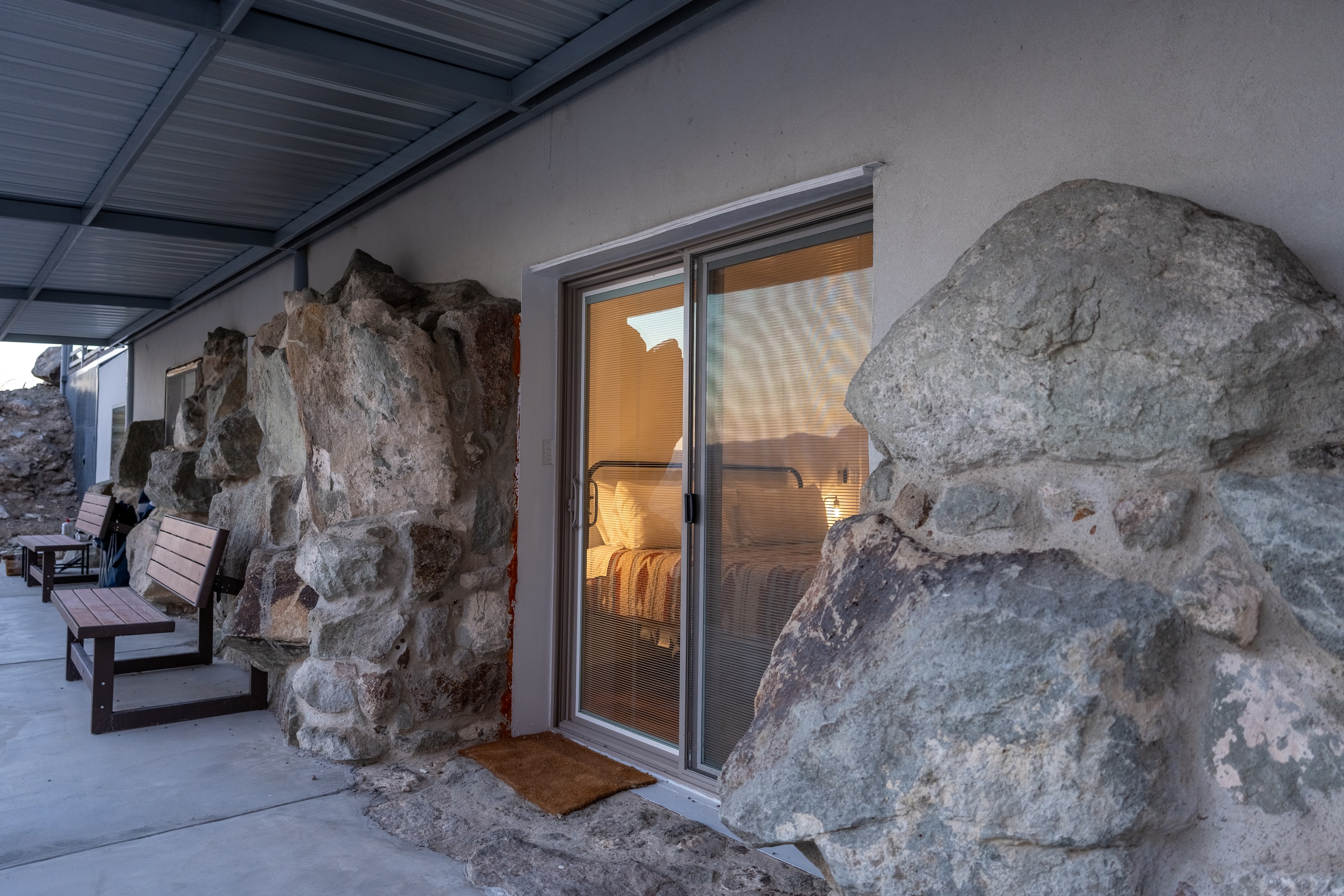 Modern cabin built between giant boulders