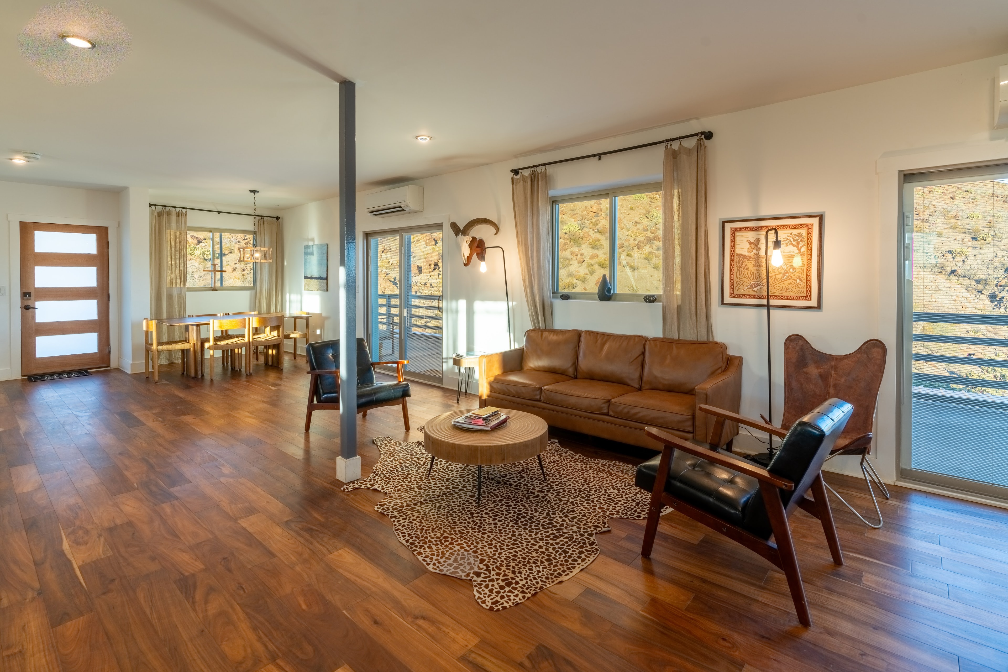 Open-concept living room at Willow Mountain Ridge with leather sofa and warm natural light