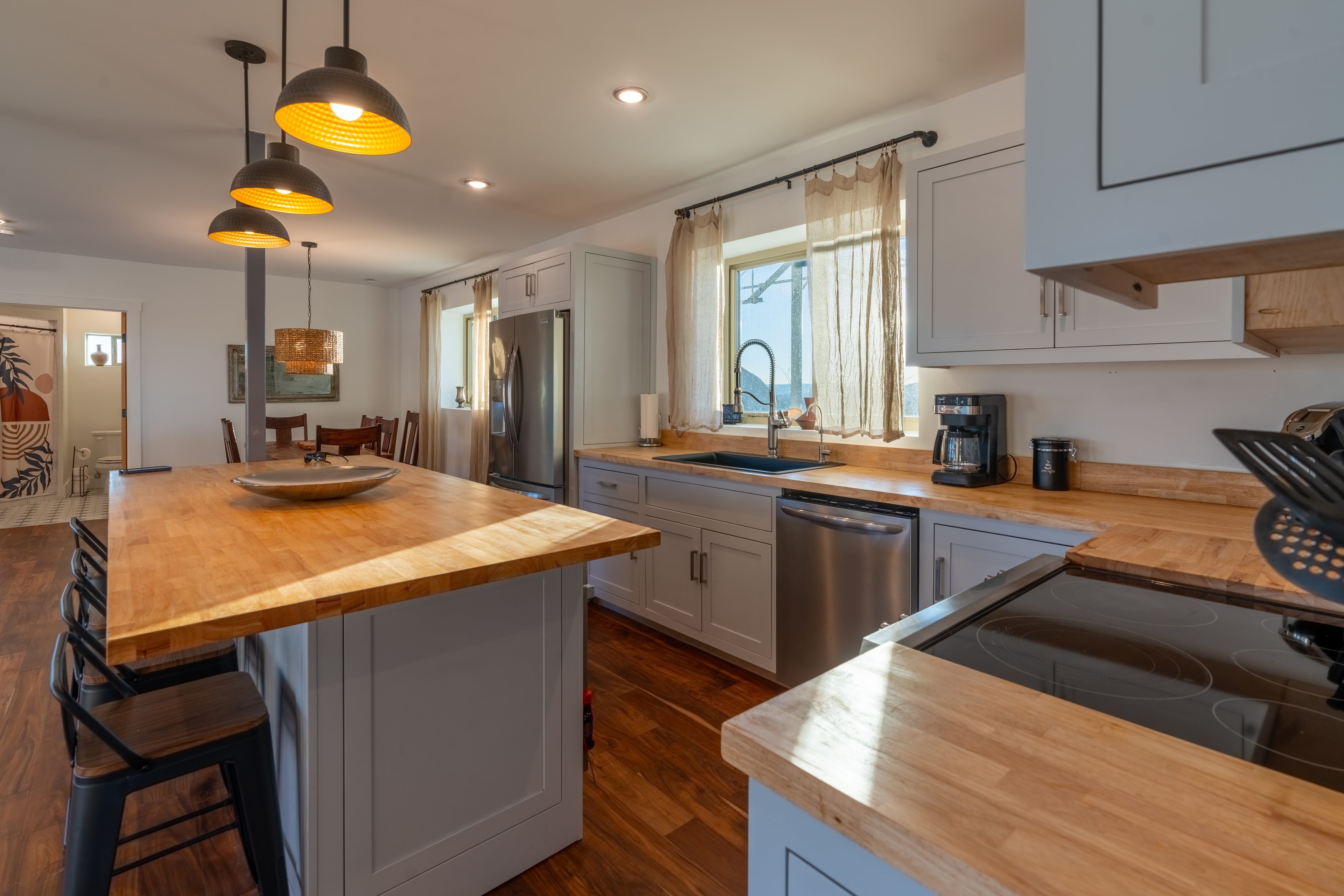 Modern kitchen with wood countertops and pendant lights