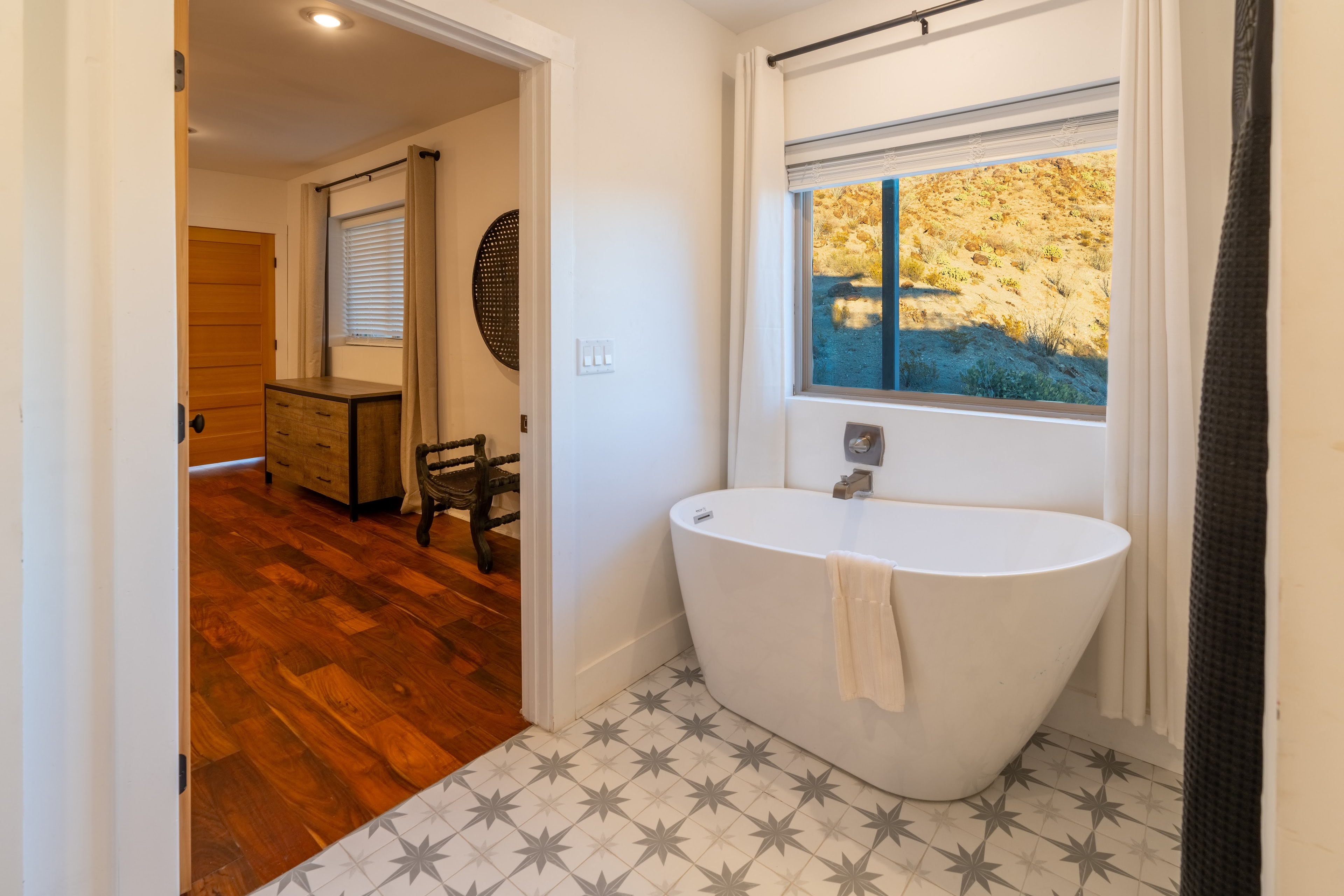Modern bathroom with freestanding tub and window