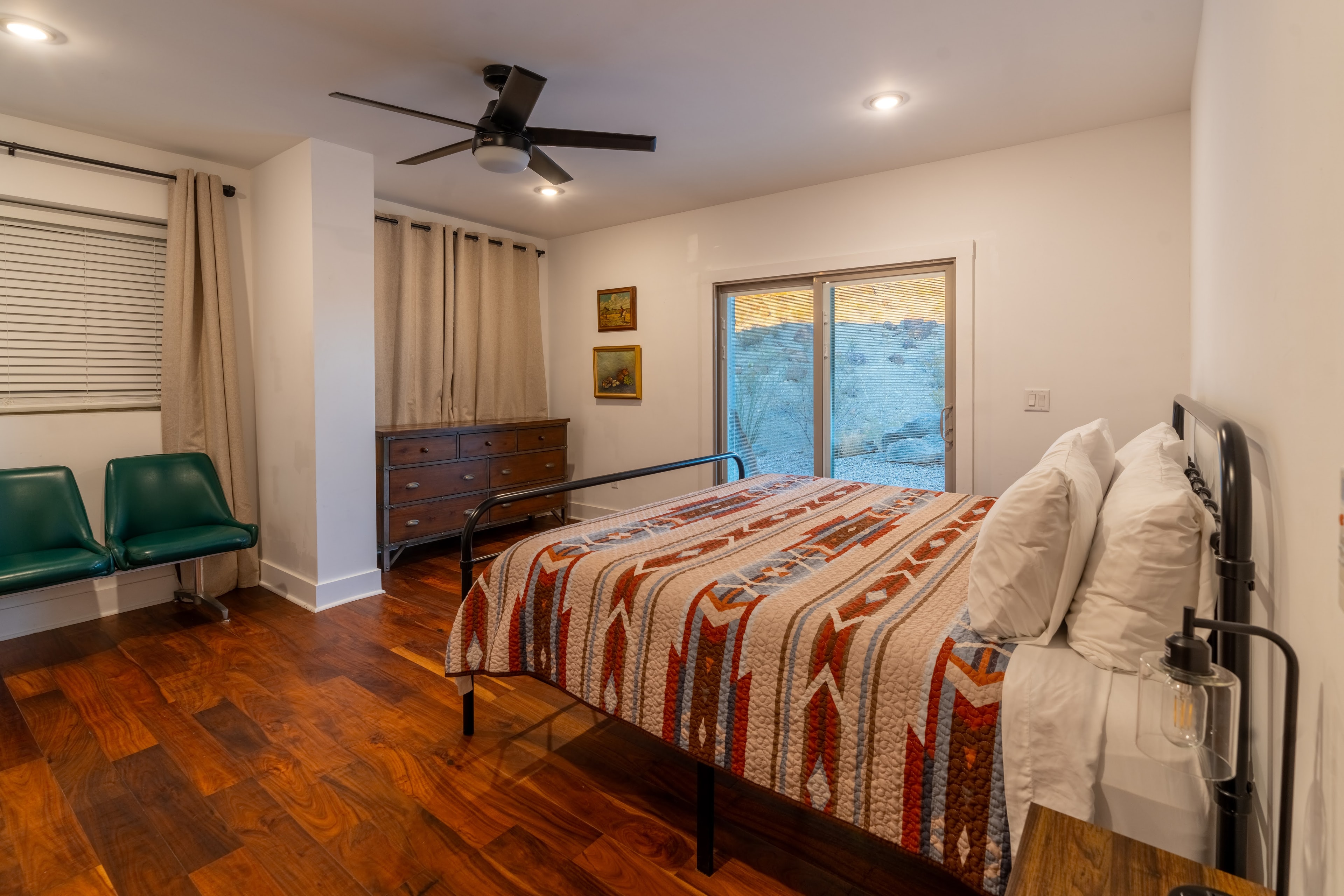 Modern bedroom with wood flooring and desert view