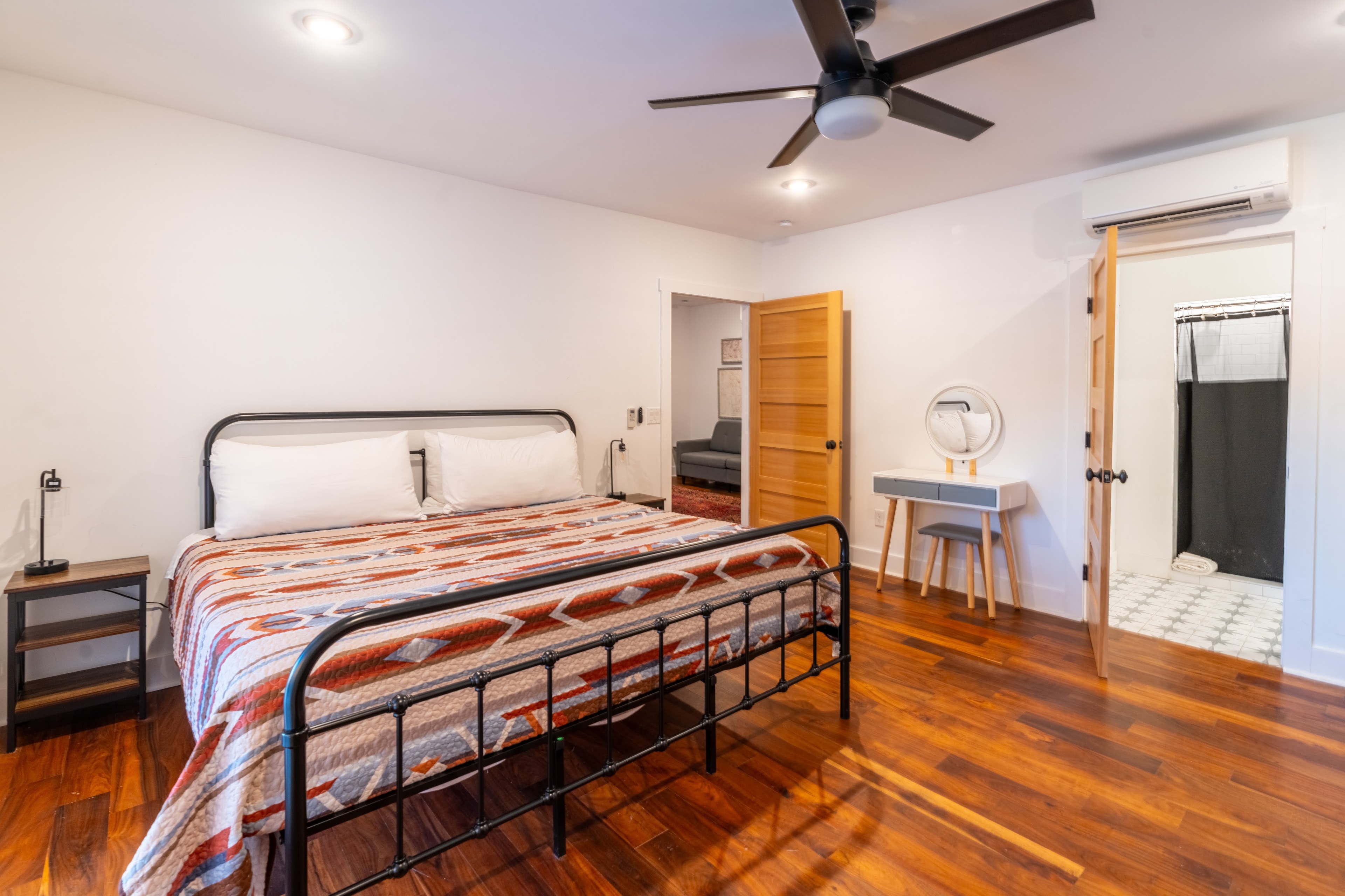 Modern bedroom with hardwood floors and ceiling fan