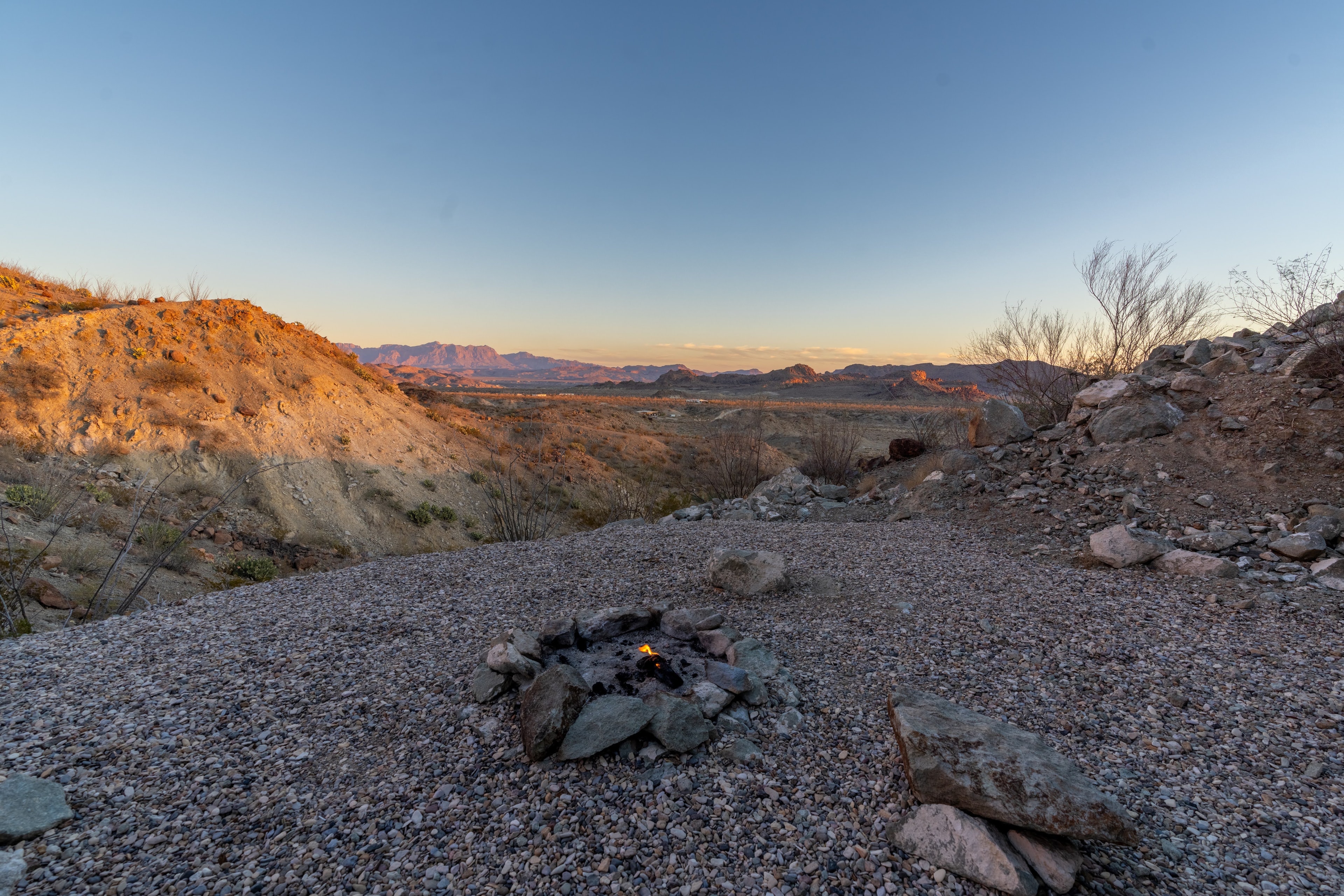 Campfire burning at dusk on the Willow Mountain Ridge property